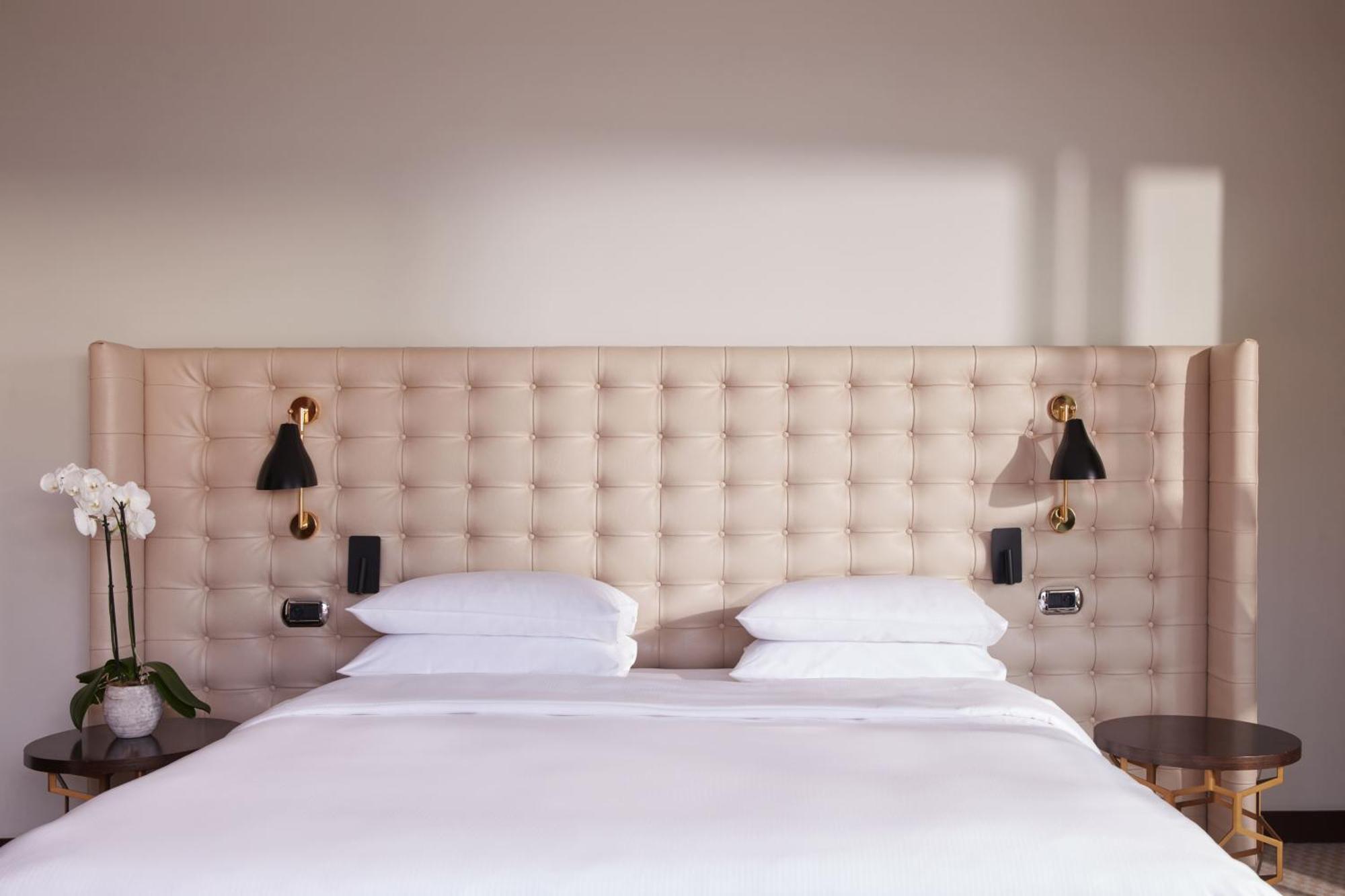Hyatt Regency Nice Palais De La Mediterranee Exterior photo A bed with a tufted headboard